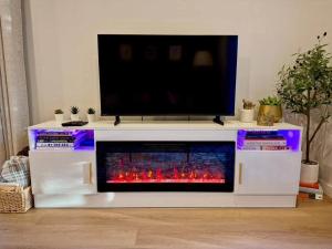 a white entertainment center with a tv on top at Island Coastal Retreat in Nanaimo +28 photos