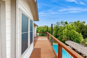 a balcony with a view of a house at Bacliff Family Getaway w/ Game Room + Private Pool in Bacliff