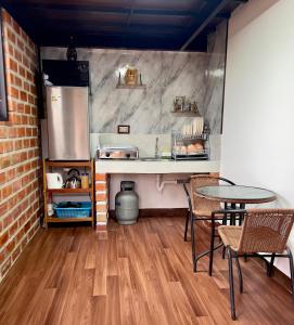 a kitchen with a counter and a table and chairs at Casa raíz in Cusco