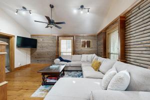 a living room with a couch and a ceiling fan at Bacliff Family Getaway w/ Game Room + Private Pool in Bacliff