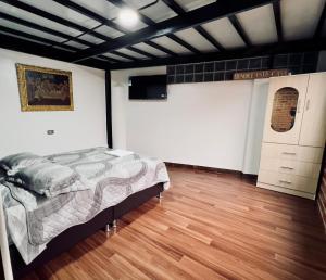 a bedroom with a bed and a television in it at Casa raíz in Cusco