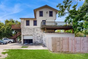 a house with a deck and a fence at Bacliff Family Getaway w/ Game Room + Private Pool in Bacliff