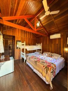 a bedroom with two beds and a ceiling fan at Pousada Sabiá in Brotas +40 photos