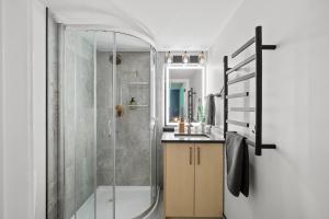 a bathroom with a shower and a sink at Cosmic Game Room, Yard & Close to WEM in Spruce Grove +33 photos
