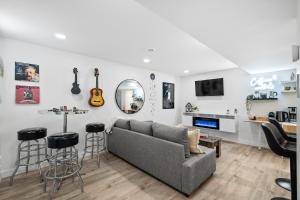 a living room with a couch and a bar at Cosmic Game Room, Yard & Close to WEM in Spruce Grove