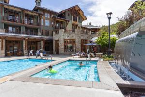 a pool at a hotel with people playing in it at Hyatt Centric Park City in Park City