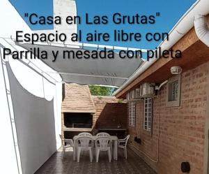 a balcony with a table and chairs on a patio at Casa en Las Grutas in Las Grutas