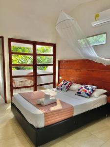 a bedroom with a large bed in a room at Manigua Tayrona Hostel in Santa Marta