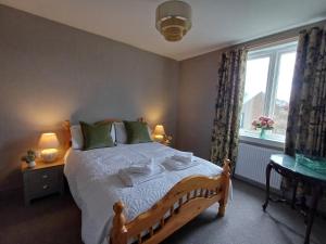 a bedroom with a large bed and a window at Number 47 in Hawick