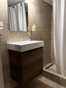 a bathroom with a sink and a shower at Blue two apartment in Kavála