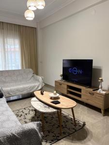 a living room with a tv and a coffee table at Blue two apartment in Kavála