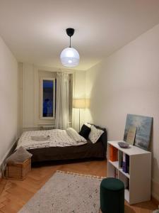 a bedroom with a large bed and a table at Central Cozy Rooms in Zurich +5 photos