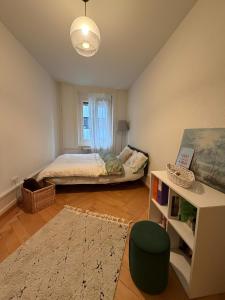 a small bedroom with a bed and a window at Central Cozy Rooms in Zurich