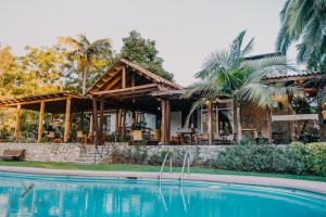 a house with a pool in front of it at Hotel Fundo Las Tortolas in Limache