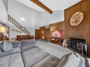 a living room with a couch and a fireplace at Giant Steps 28 Ski in out in Brian Head