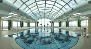 a large swimming pool with a glass ceiling at Grand Altuntas Hotel in Aksaray