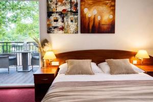a bedroom with a large bed and a balcony at Morska Fala in Pobierowo +99 photos