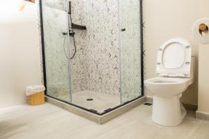 a bathroom with a shower with a toilet at 2Surf Sunzal in El Sunzal