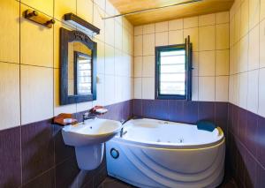 a bathroom with a large tub and a sink at Къща за гости Старият Град Златоград in Zlatograd +14 photos