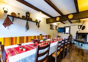 a dining room with a long table and chairs at Къща за гости Старият Град Златоград in Zlatograd