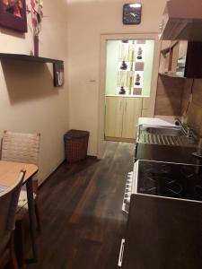 a kitchen with a stove and a counter top at Home Apartman in Debrecen