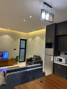 a living room with a couch and a tv at Bright 1BR Apartment Close to Everything in Kigali