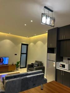 a living room with a couch and a tv at Bright 1BR Apartment Close to Everything in Kigali