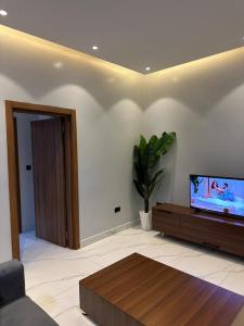 a living room with a flat screen tv on a wall at Bright 1BR Apartment Close to Everything in Kigali