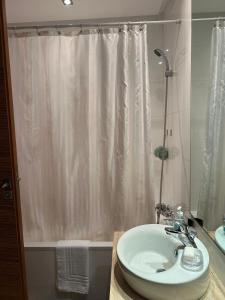 a bathroom with a white shower curtain and a sink at View green garden ligue arabe in Casablanca +10 photos