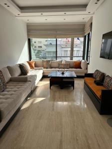 a living room with a couch and a table at View green garden ligue arabe in Casablanca