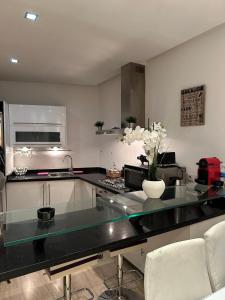 a kitchen with a counter with a vase of flowers on it at View green garden ligue arabe in Casablanca