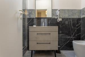 a bathroom with a sink and a mirror at Delux Via Faenza in Florence