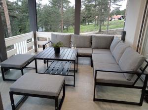 a living room with a couch and a table at Yes Boss House Divcibare in Divčibare