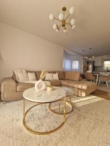 a living room with a couch and a table at Yes Boss House Divcibare in Divčibare