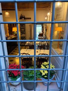 a view from a window of a restaurant with tables and flowers at Le 3 Rane B&B in Treggiaia