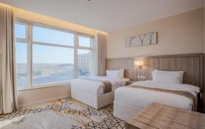 a hotel room with two beds and a large window at Grand Line in Tabuk +51 photos