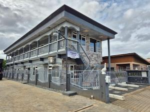 a building with a balcony on the side of it at Donfarsha Apartments in Paramaribo