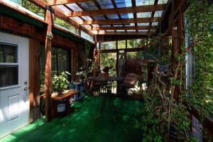 an outdoor patio with a wooden pergola and a table at Crispin Cottage in Philo