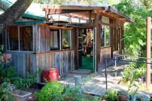 a wooden house with a front door and a porch at Crispin Cottage in Philo