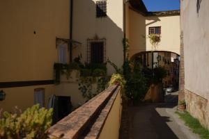 a bench in front of a building with plants at Le 3 Rane B&B in Treggiaia