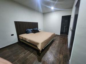 a bedroom with a bed and a wooden floor at Quinta el molino in Parras de la Fuente