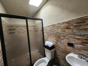 a bathroom with a toilet and a sink at Quinta el molino in Parras de la Fuente +13 photos