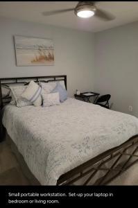 a bedroom with a large bed with white sheets and pillows at Downtown and Inner Harbor Apartment in Baltimore