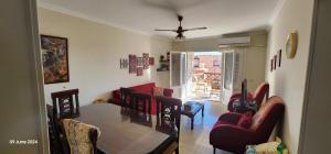 a living room with a table and chairs at Lazorde Bay Apartment in El Alamein