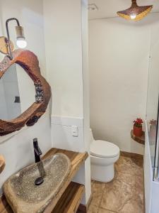 a bathroom with a sink and a toilet at Canela Mountain Villa Hotel in Salento +65 photos