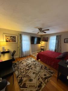 a bedroom with a red bed and a rug at Natalie House in Boston
