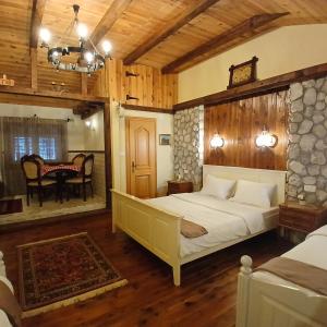 a bedroom with a bed and a table in a room at Vila Merak in Gusinje +104 photos