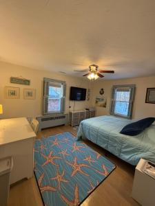 a bedroom with a bed and a table and a tv at Natalie House in Boston