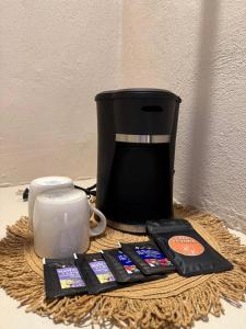 a coffee maker and other items on a table at CASA VICTORIA in Chichén-Itzá
