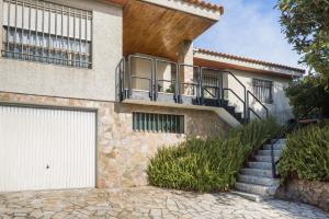 a house with a staircase leading to a garage at Casa TINA in A Guarda